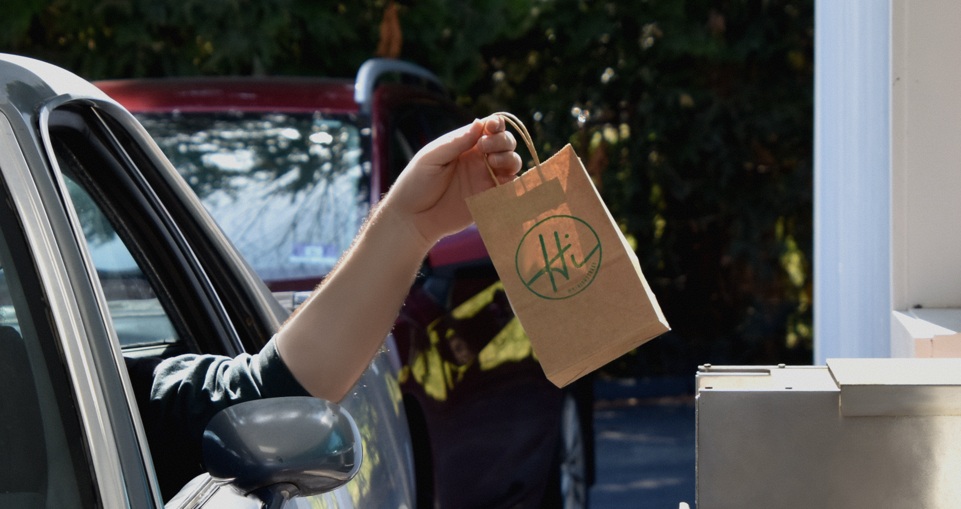 Man in car using the new drive thru option at New Jersey cannabis shop.